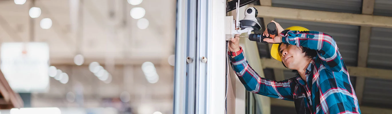 A CCTV expert fixing a cctv at an office space