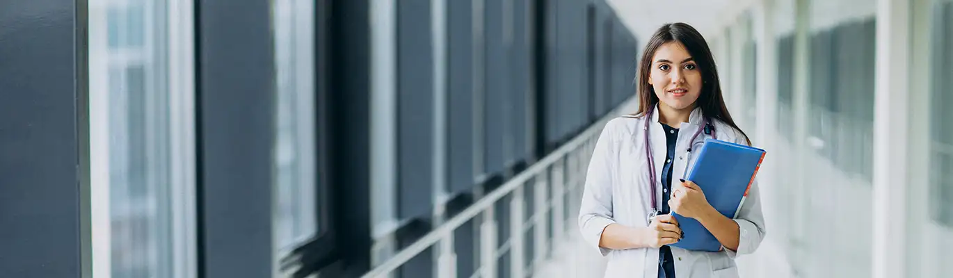 A picture of a medical student with coat and stethescope