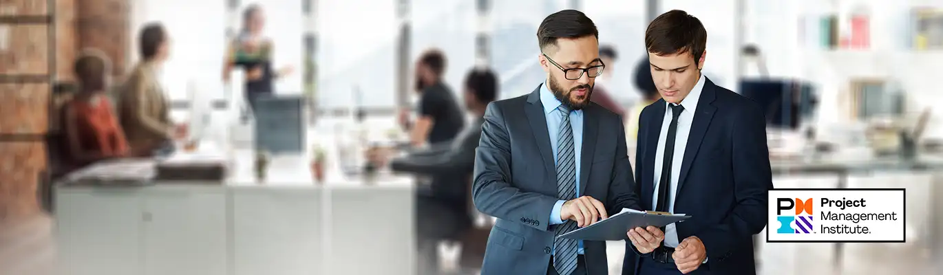 Two professionals having a discussion with a notepad in hand 