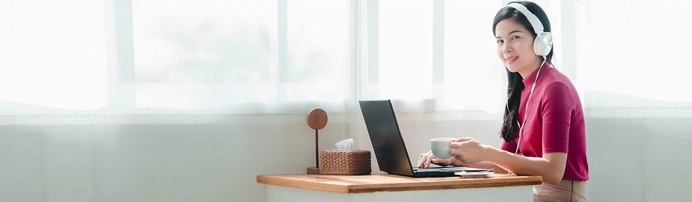 A student sitting infront of a laptop and learning about Python Course 