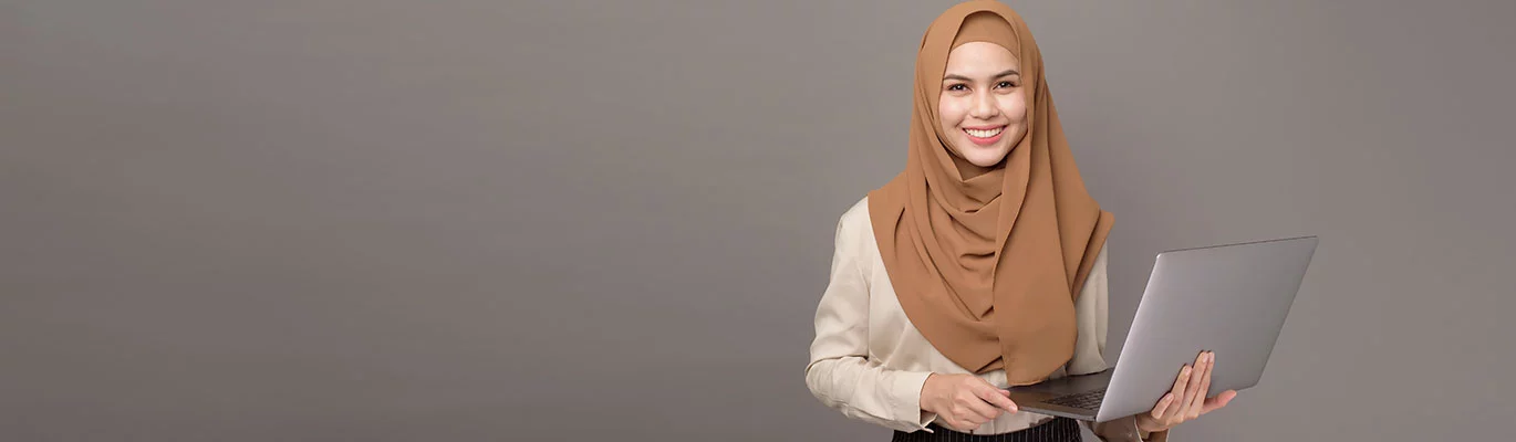 A web development student holding laptop in her her hand.