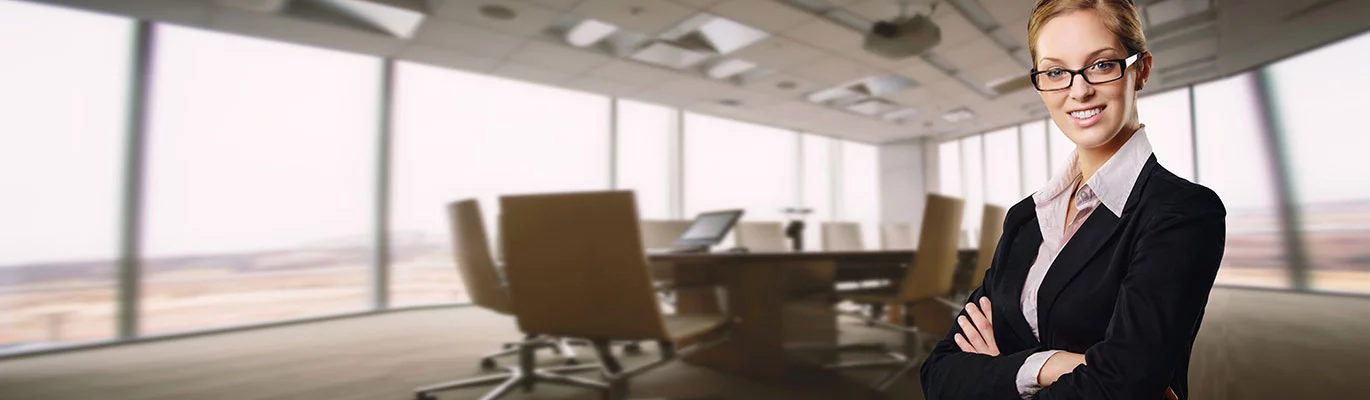 An HR professional standing in front of a borad meeting room.