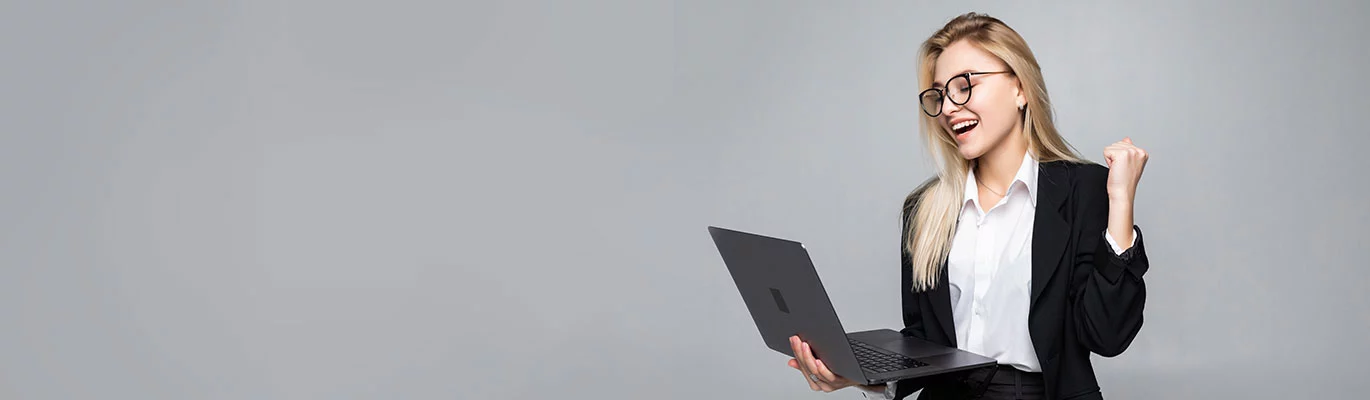 A full stack developer in executive look sitting with her laptop