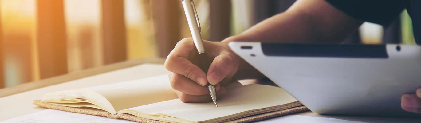 A MS Access student taking down notes from a training session