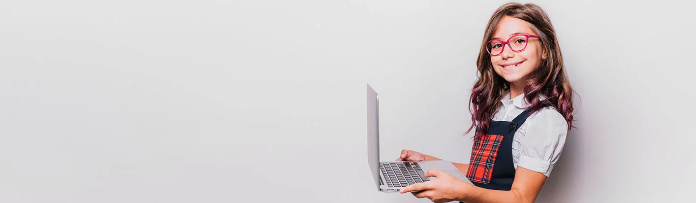 A kid holding the laptop and learning about Python Course