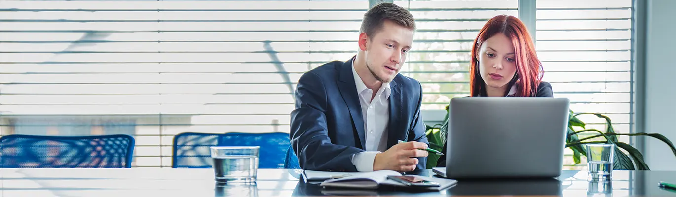 Salesforce Administrator professionals sitting infront of a laptop