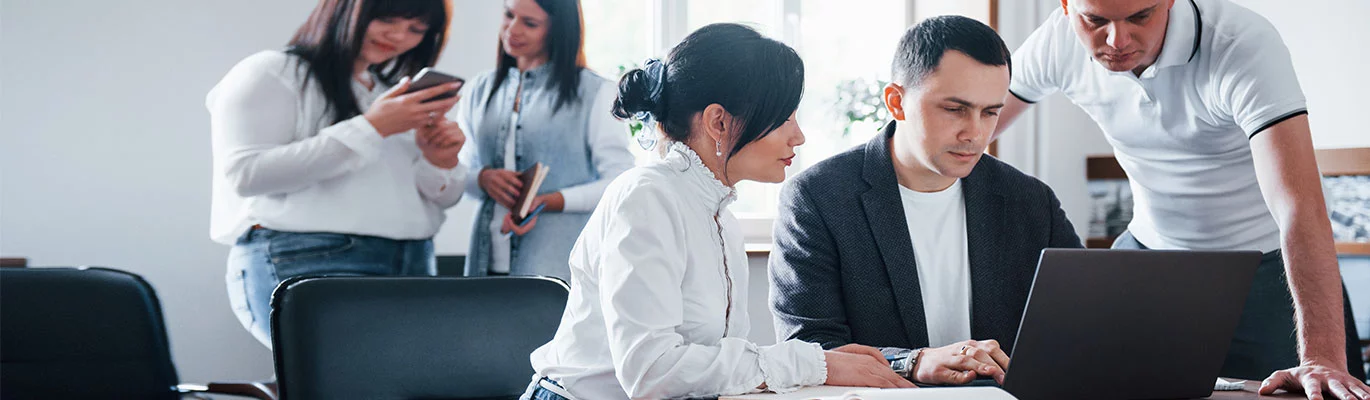 Microsoft Project professionals on work discussion with a laptop infront of them