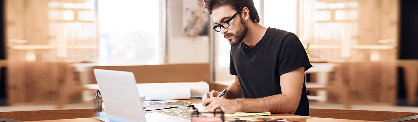 A student is studying the AutoCAD 2D Course while sitting in front of the Laptop