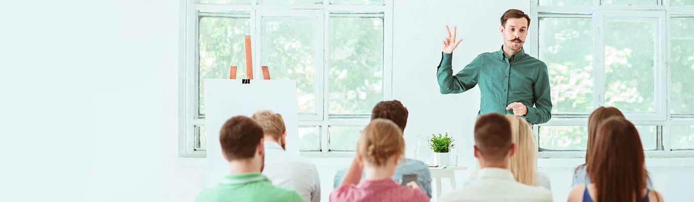 A Leader educating his team on public speaking skills