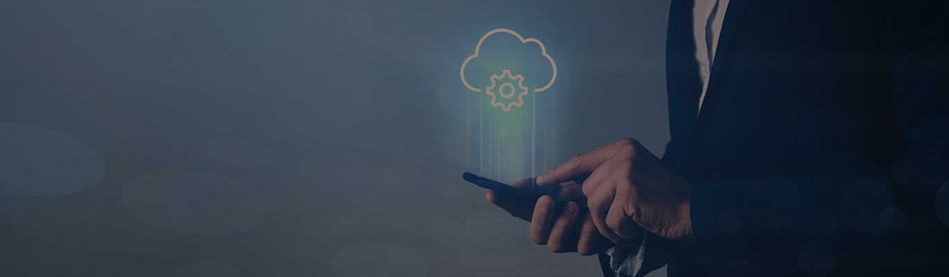 A cloud computing professional using a mobile phone from which the image of a cloud is projecting upwards