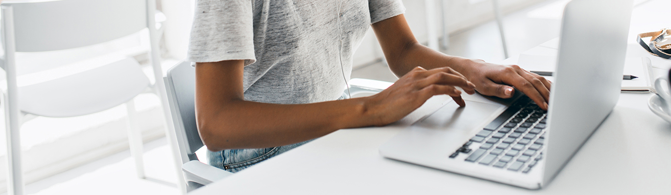 A VMware student is typing on a laptop