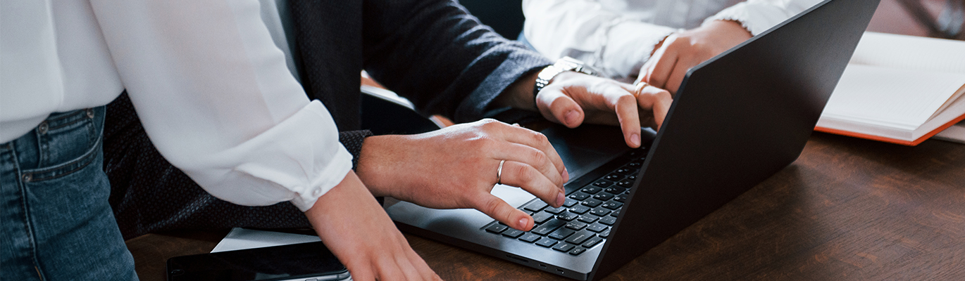 Three citrix students are working on a laptop 