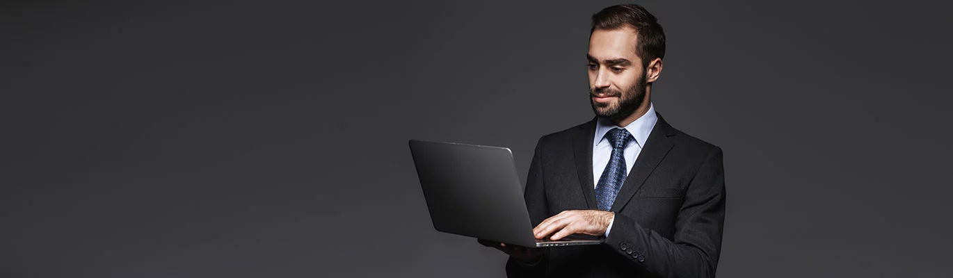 CCP professional holding a laptop and smiling