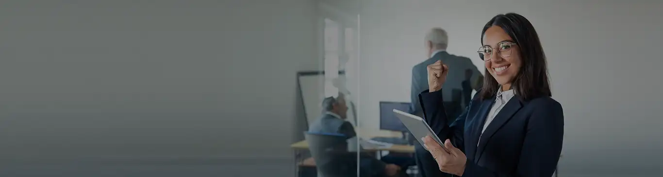 Contracts Management student holding a tablet and victory smiling