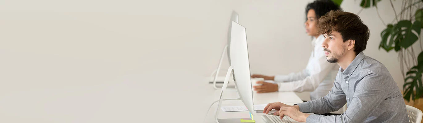 Blender students sitting infront of a computer and learning