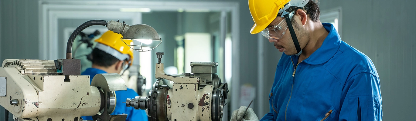 A mechanical design professional operating a machine at workplace